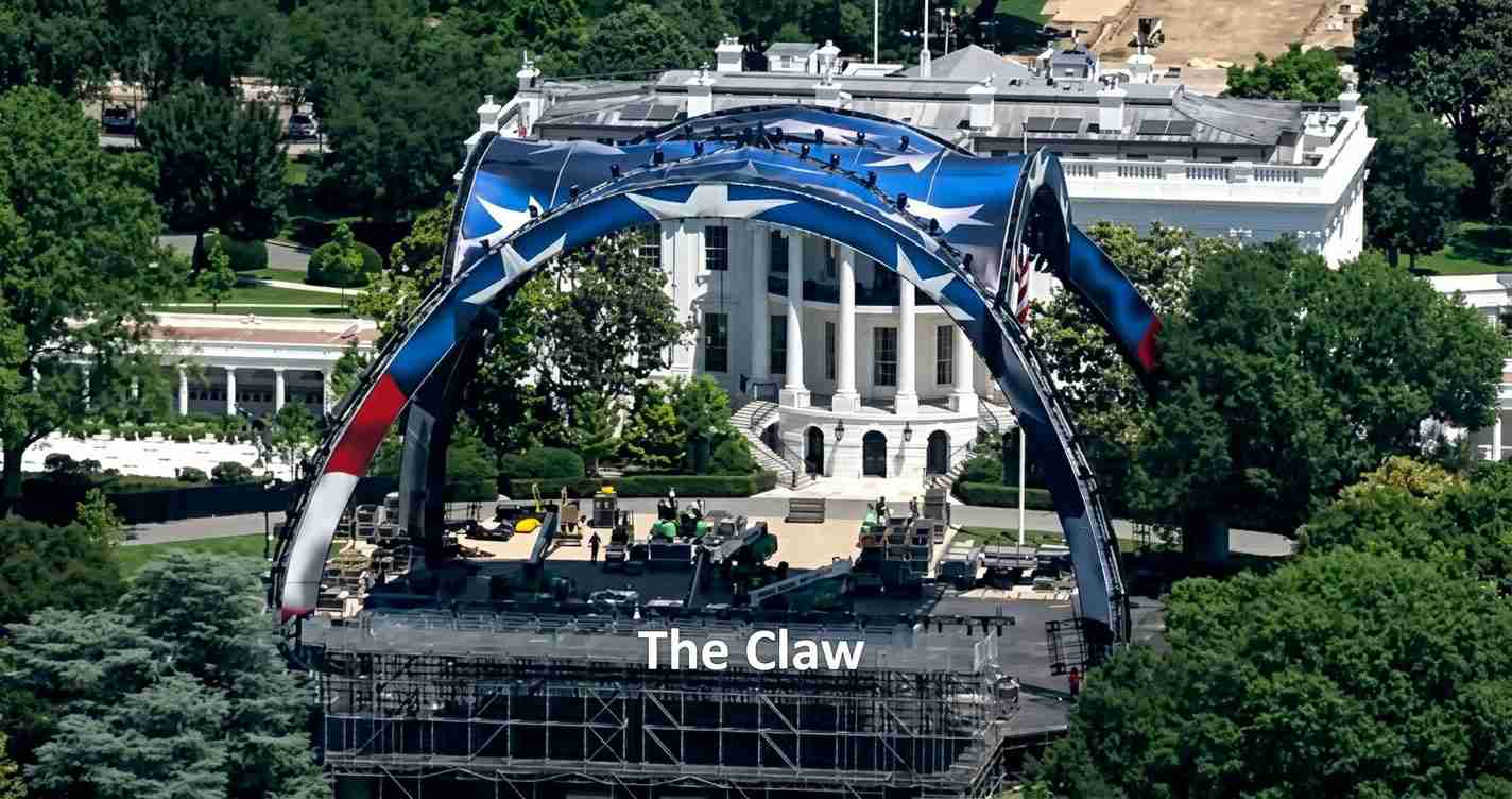 Overhead view of a massive curved stage rig with a blue-red-white arch in front of a white neoclassical building, labeled 'The Claw' on the front.
