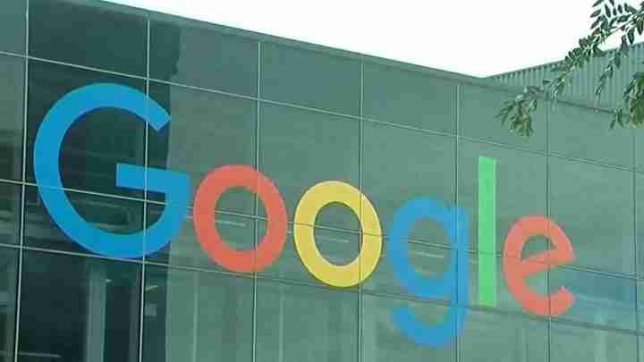 Google logo on a glass office building facade.